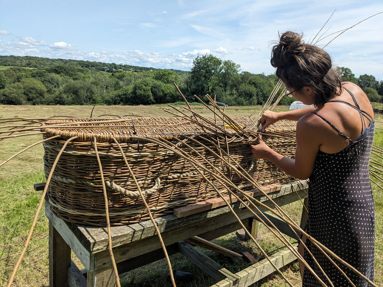 Liv, weaving a coffin by hand