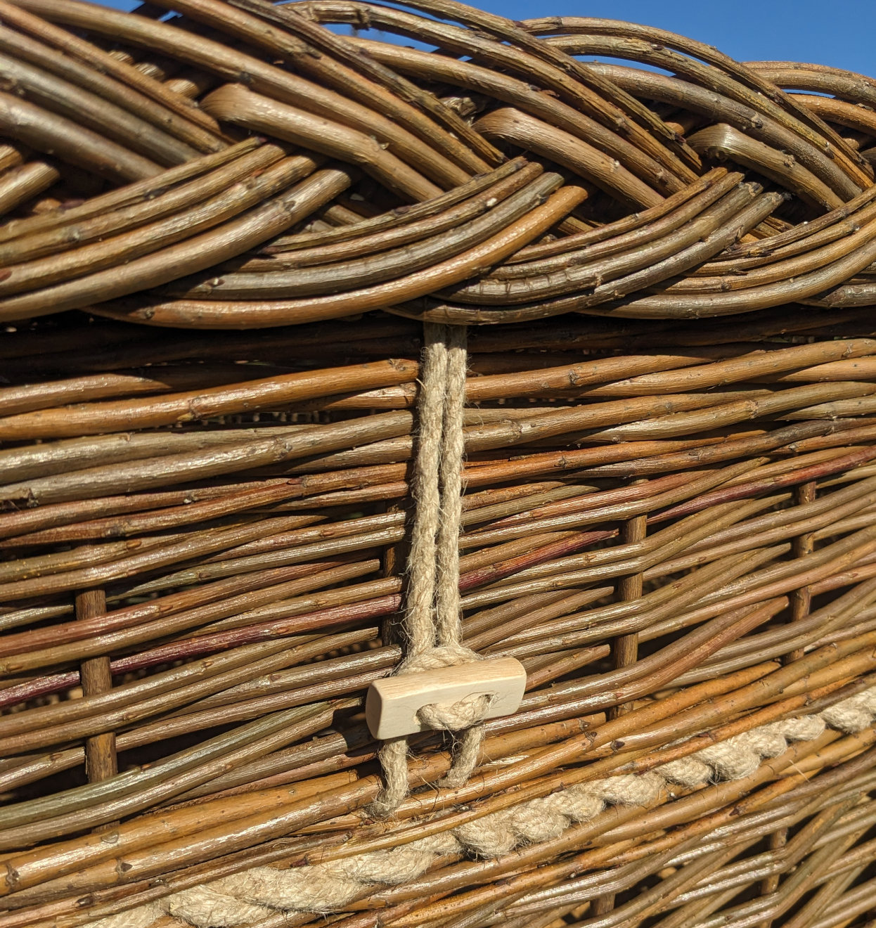 Brown willow coffin with wooden toggle